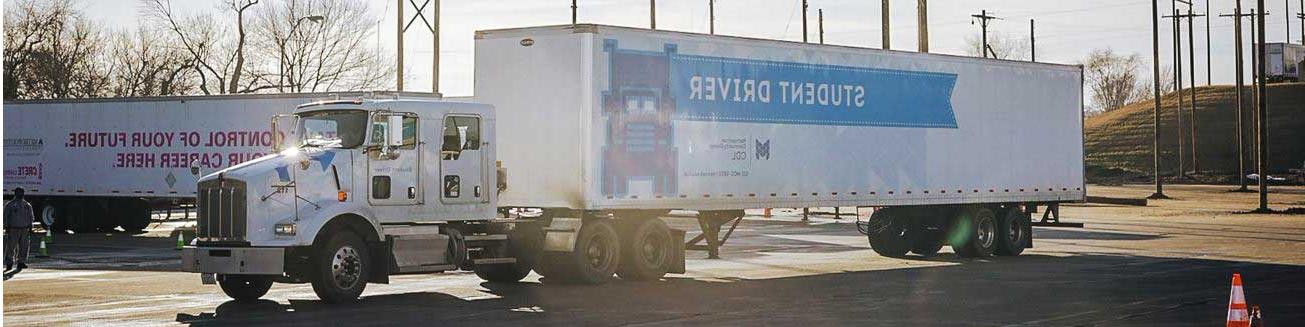 A semi with an OPE电子竞技官网 CDL-branded trailer that reads "student driver"